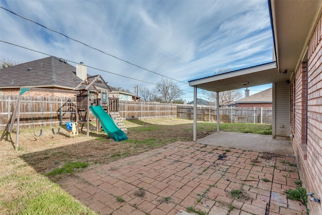 view of patio / terrace with a playground and a fenced backyard