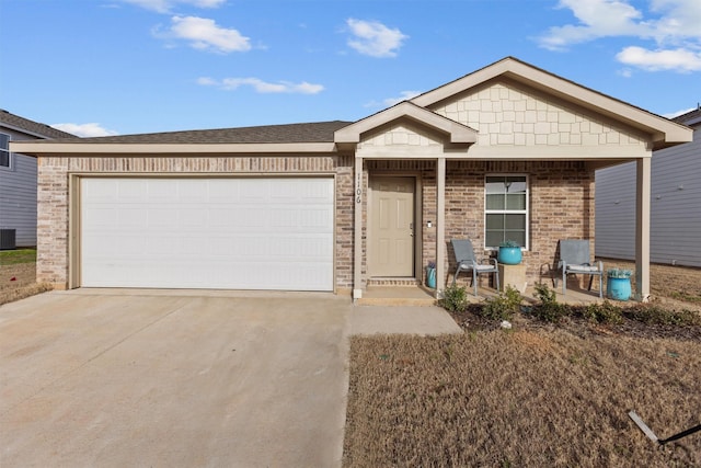 ranch-style home with a garage, covered porch, brick siding, and driveway