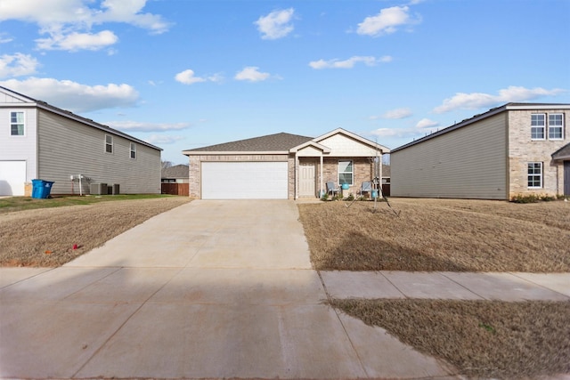 view of front facade featuring driveway, a garage, brick siding, central AC, and a front yard