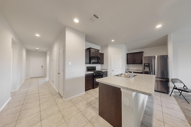 kitchen with visible vents, light countertops, dark brown cabinets, black appliances, and a sink