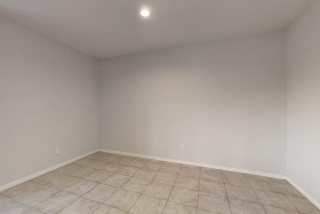 unfurnished room with recessed lighting and baseboards