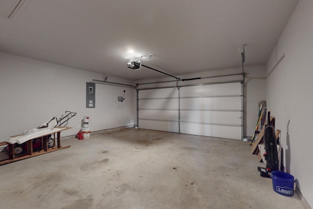 garage with a garage door opener and electric panel