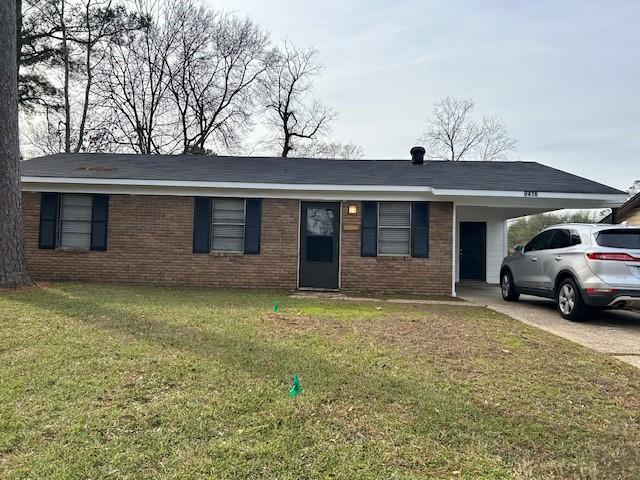 single story home featuring a carport, concrete driveway, brick siding, and a front lawn