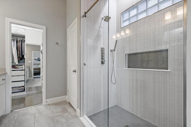 full bath featuring baseboards and walk in shower