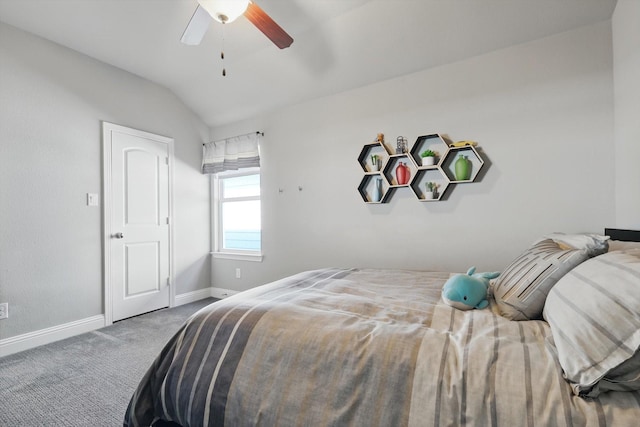 carpeted bedroom featuring baseboards, vaulted ceiling, and a ceiling fan