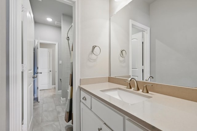 full bath featuring walk in shower and vanity