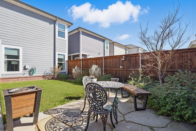 view of patio featuring outdoor dining space and fence