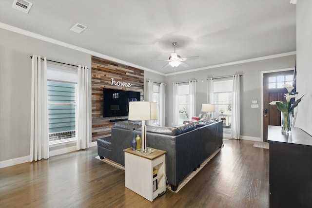 living room with ornamental molding, baseboards, visible vents, and dark wood-type flooring