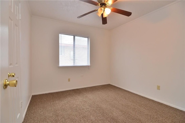 carpeted spare room with baseboards, ceiling fan, and crown molding