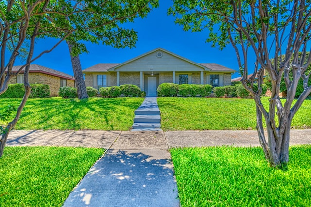 view of front of home featuring a front lawn and brick siding
