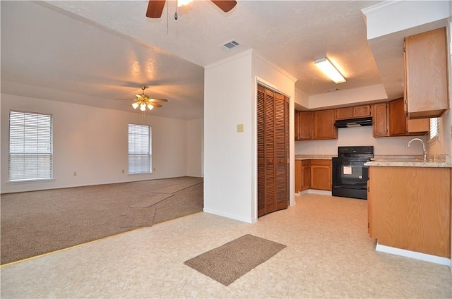 kitchen featuring under cabinet range hood, visible vents, open floor plan, light countertops, and range