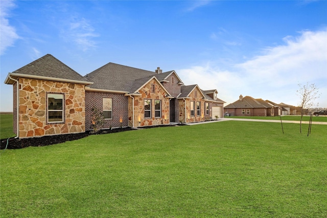 view of front of house featuring stone siding, roof with shingles, a chimney, and a front lawn