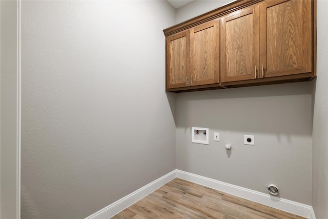 laundry room with hookup for a gas dryer, washer hookup, baseboards, cabinet space, and electric dryer hookup