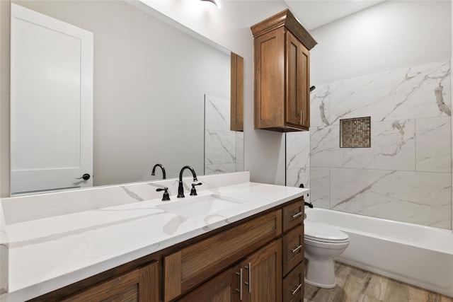 full bathroom featuring toilet, shower / tub combination, wood finished floors, and vanity