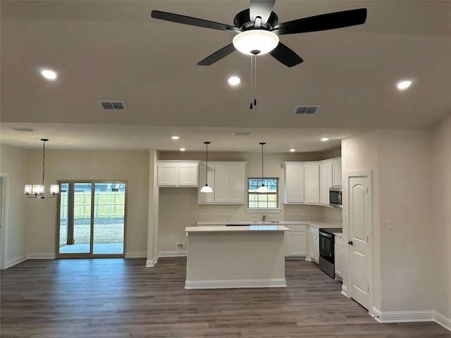 1727 Russell Dr, Garland, TX 75040 - kitchen featuring stainless steel microwave, black / electric stove, a sink, baseboards, and recessed lighting