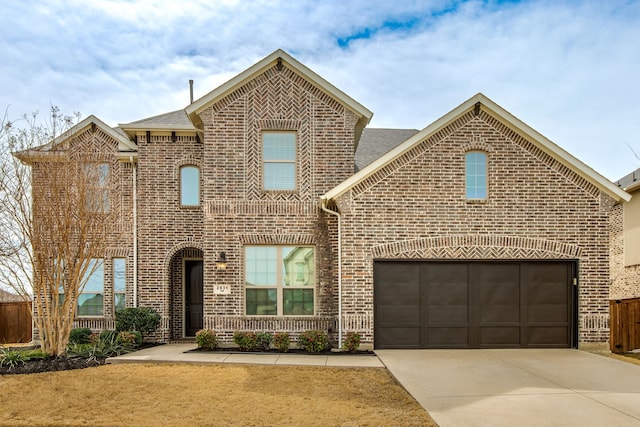 view of front facade with a shingled roof, brick siding, driveway, and an attached garage