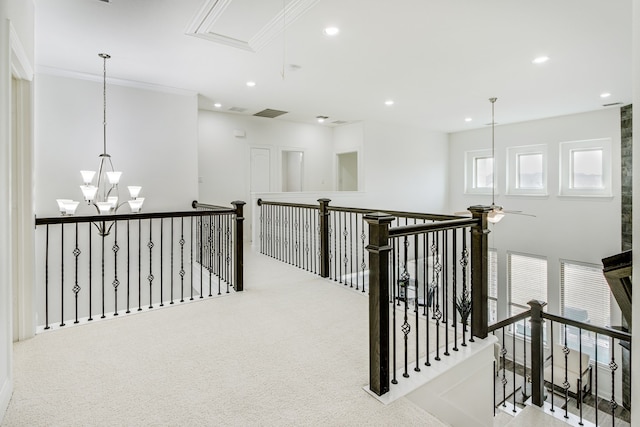 corridor with recessed lighting, an upstairs landing, carpet, attic access, and an inviting chandelier