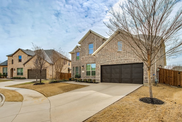 traditional-style house with concrete driveway, brick siding, and fence