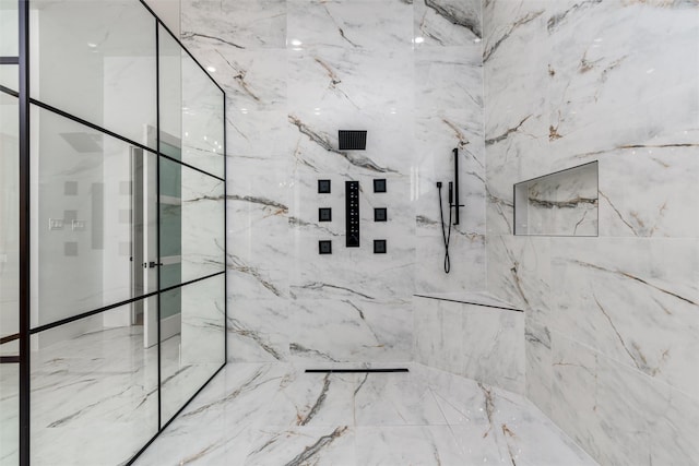 bathroom featuring a marble finish shower