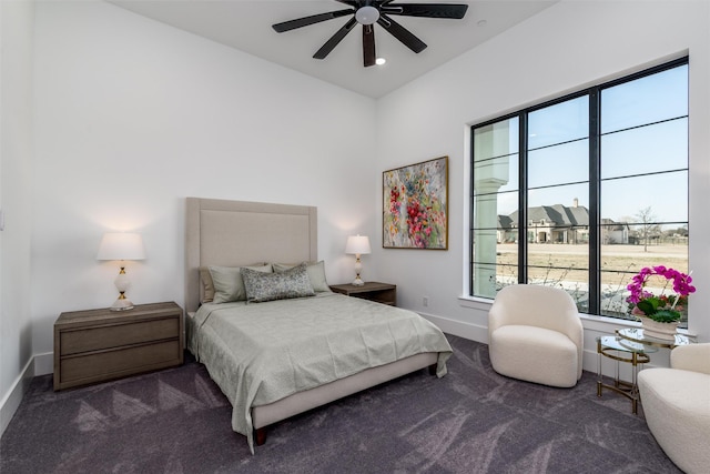 bedroom with a ceiling fan, baseboards, and carpet floors