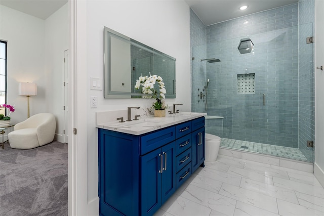 bathroom with marble finish floor, a stall shower, and a sink