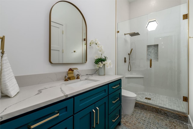 bathroom featuring vanity, toilet, and a stall shower