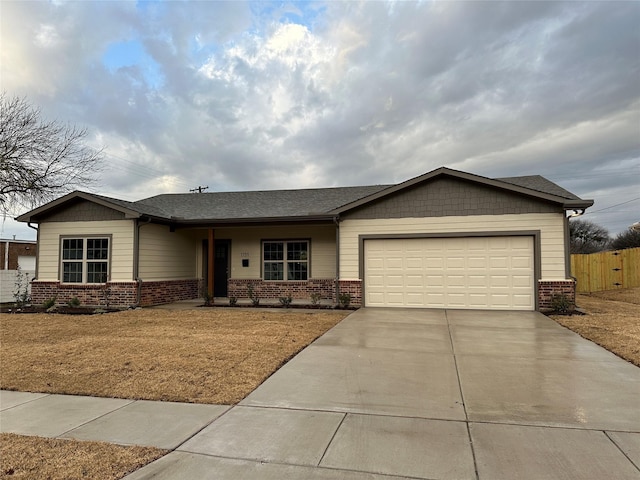 view of front of property with a garage, brick siding, fence, and driveway