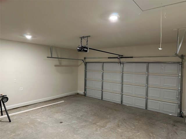 garage with baseboards and a garage door opener