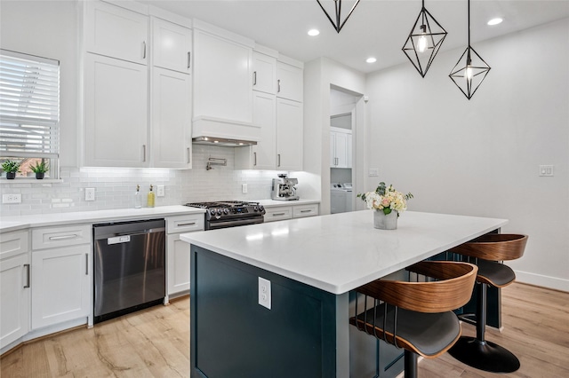 kitchen featuring light wood-style flooring, tasteful backsplash, white cabinets, and stainless steel appliances