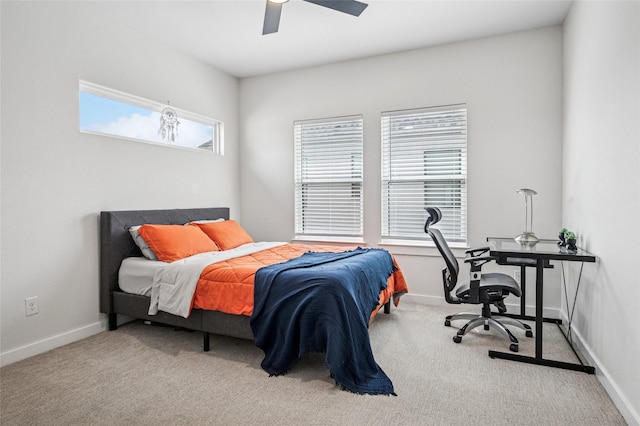 bedroom with ceiling fan, baseboards, and carpet floors