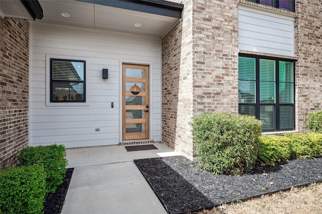 property entrance featuring brick siding