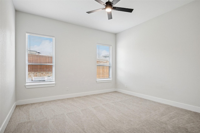 unfurnished room with ceiling fan, plenty of natural light, baseboards, and light carpet