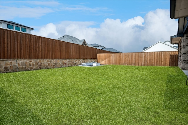 view of yard with a fenced backyard