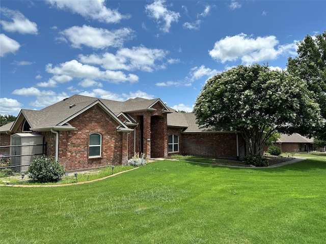 111 Partagas Dr, Weatherford, TX 76085 - view of front of property featuring brick siding, a front yard, and a shingled roof