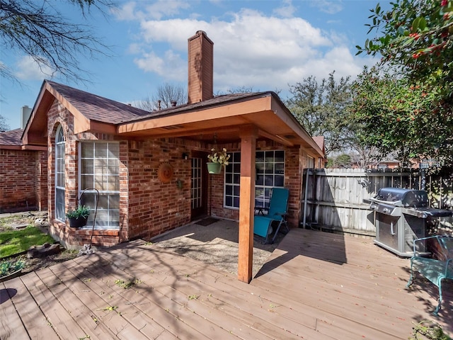 deck featuring a grill and fence