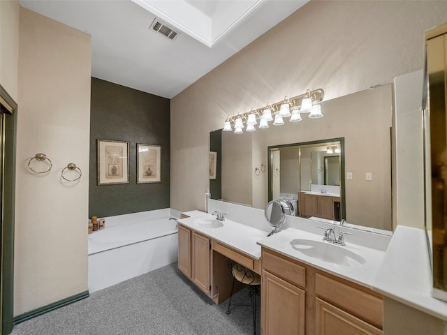 bathroom featuring visible vents, a garden tub, a sink, and double vanity