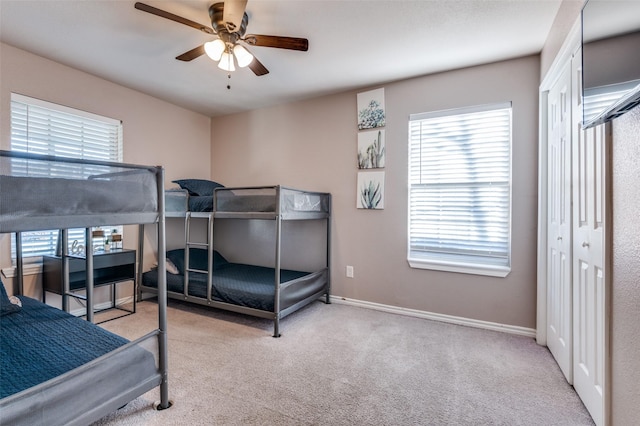 bedroom with carpet flooring, a ceiling fan, and baseboards