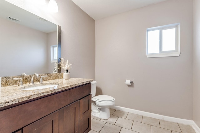 bathroom featuring a wealth of natural light, visible vents, toilet, and tile patterned floors