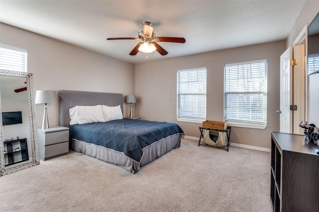 bedroom featuring carpet floors, baseboards, and a ceiling fan