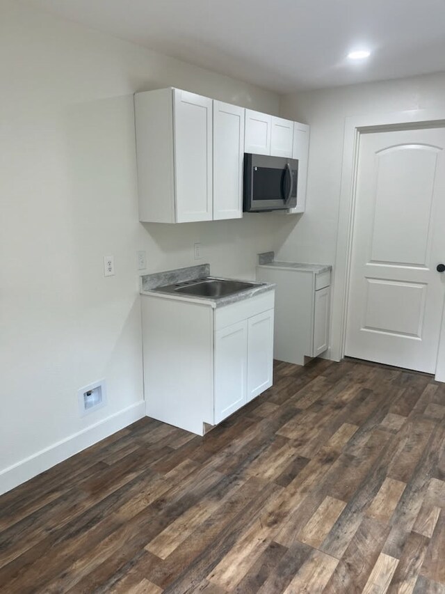 805 S Hazelwood, Sherman, TX 75090 - kitchen with stainless steel microwave, light countertops, dark wood-type flooring, white cabinets, and recessed lighting