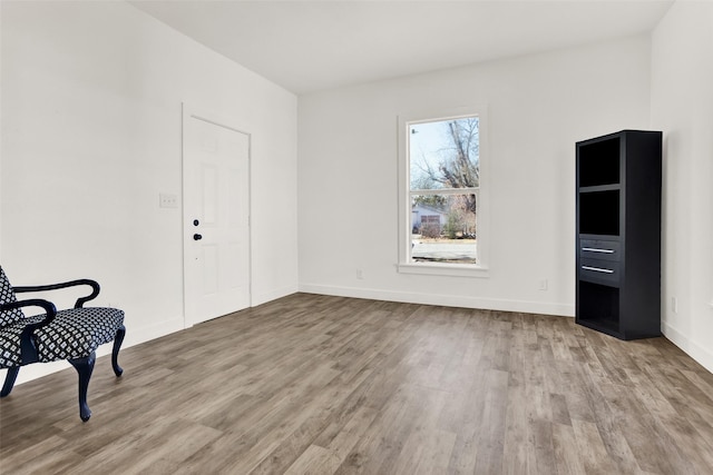 interior space with baseboards and wood finished floors