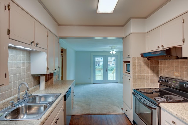 kitchen with under cabinet range hood, stainless steel appliances, a sink, white cabinets, and light countertops