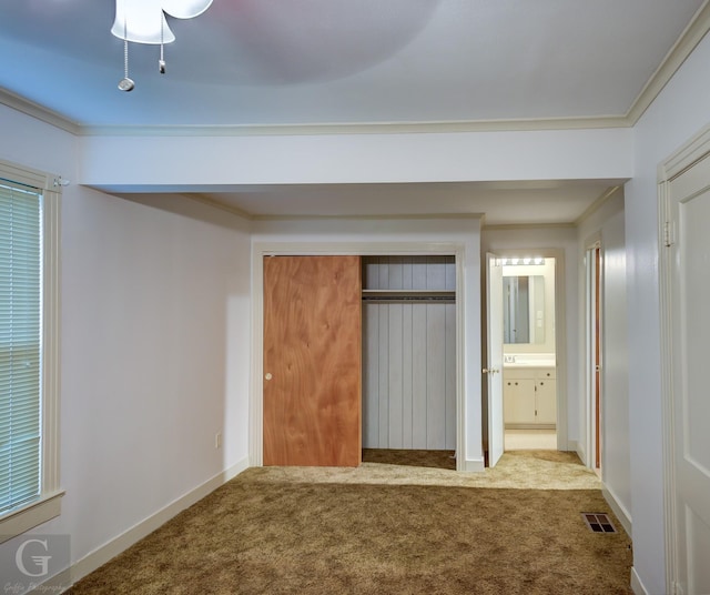 unfurnished bedroom with carpet, crown molding, visible vents, and baseboards