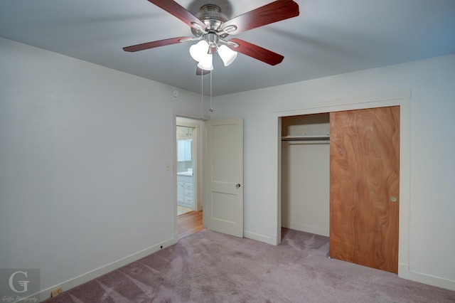 unfurnished bedroom with ceiling fan, carpet floors, a closet, and baseboards