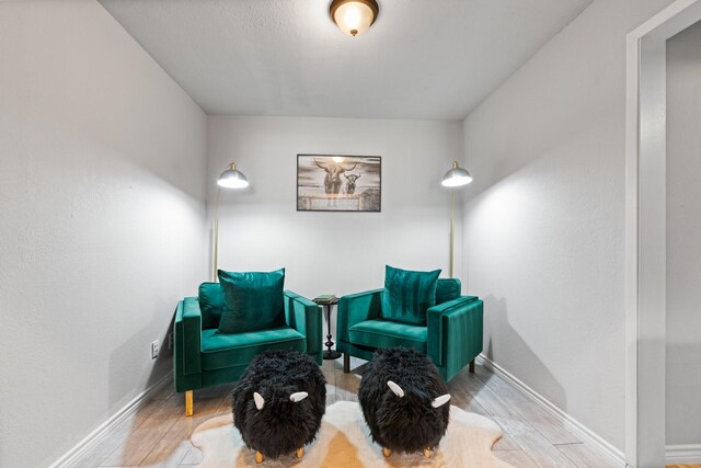 living area with wood finished floors and baseboards