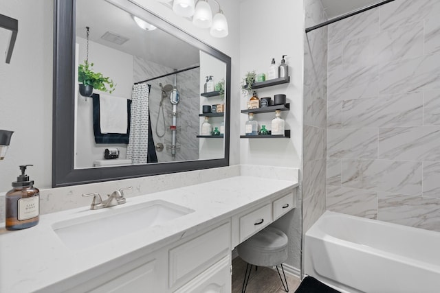 bathroom with shower / tub combo and vanity