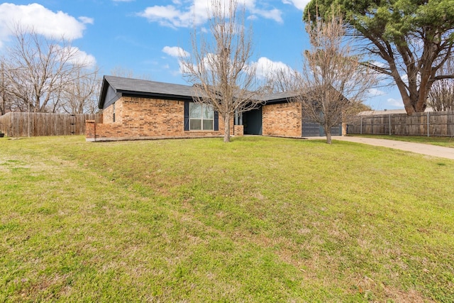 single story home featuring a front yard, brick siding, driveway, and fence