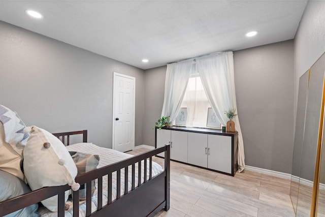 bedroom featuring recessed lighting, light wood-style flooring, and baseboards