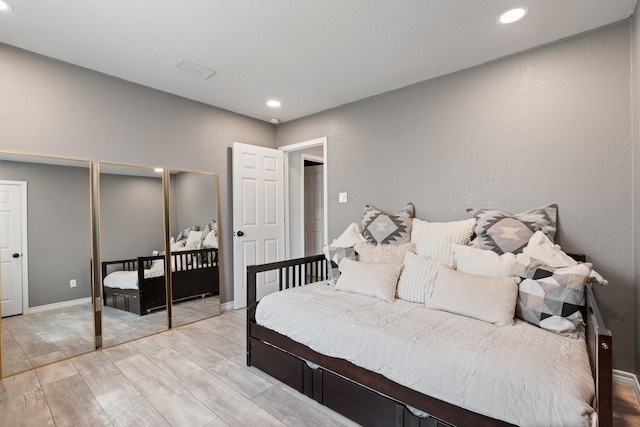 bedroom featuring light wood-style flooring, baseboards, and recessed lighting