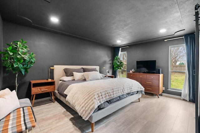 bedroom featuring recessed lighting, baseboards, and light wood finished floors